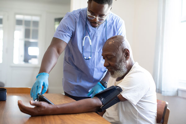 Health professional examining a patient's blood pressure