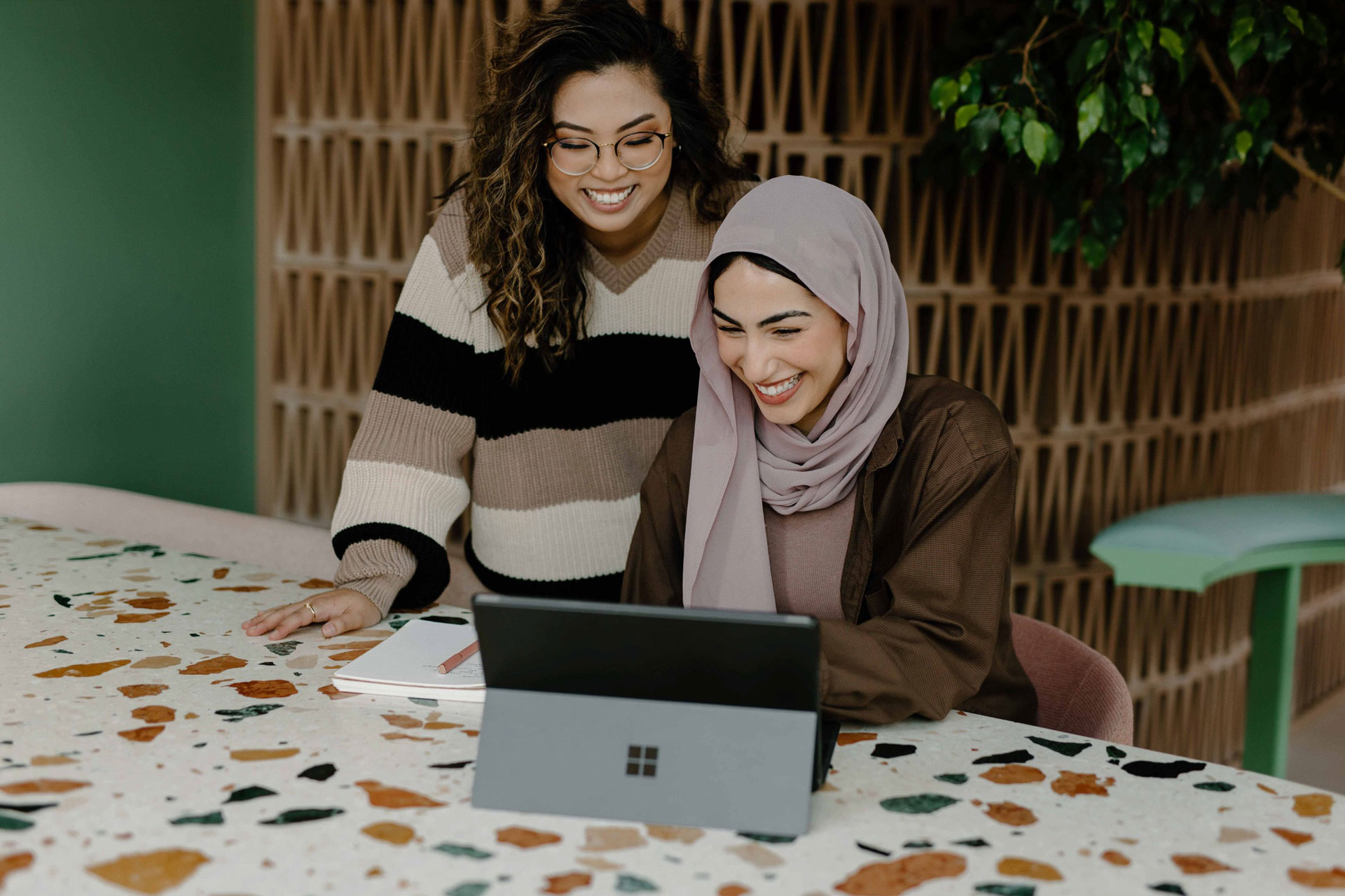 Two woman looking at laptop
