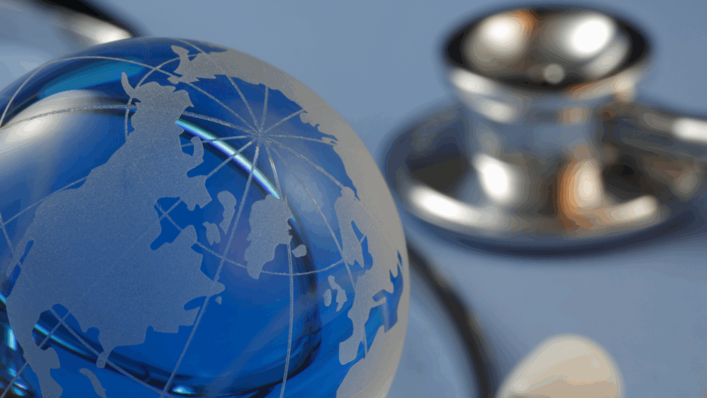 A close-up image of a glass globe, symbolising global healthcare, with a stethoscope in the background. The image conveys international medical collaboration, representing a World Health Organisation doctor visiting HCL to observe integrated care practices.